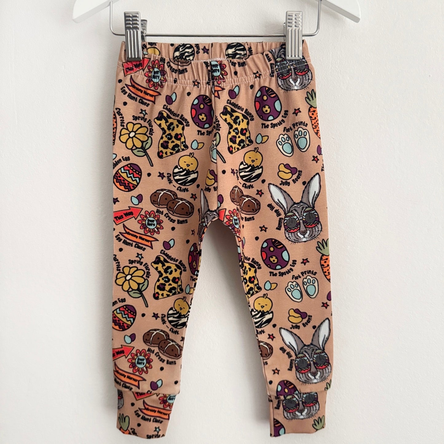Beige leggings with bright, bold Easter images on them.