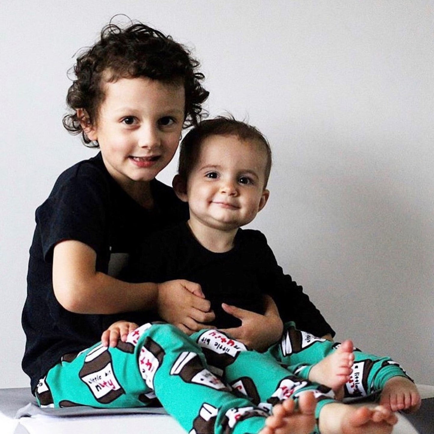 Two children matching in these leggings with black t-shirts.