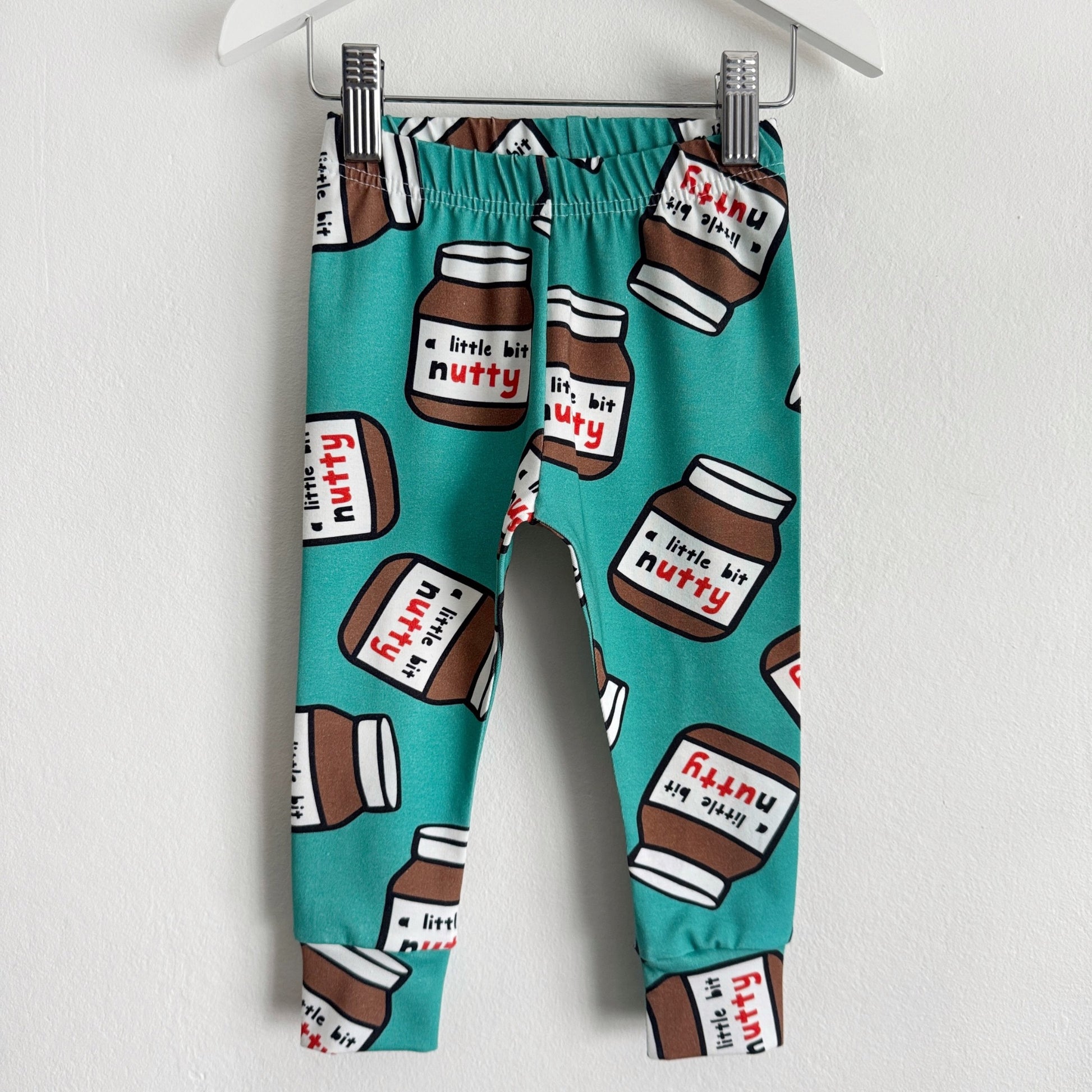 Teal coloured leggings with jars of chocolate spread on them with the phrase "a little bit nutty"