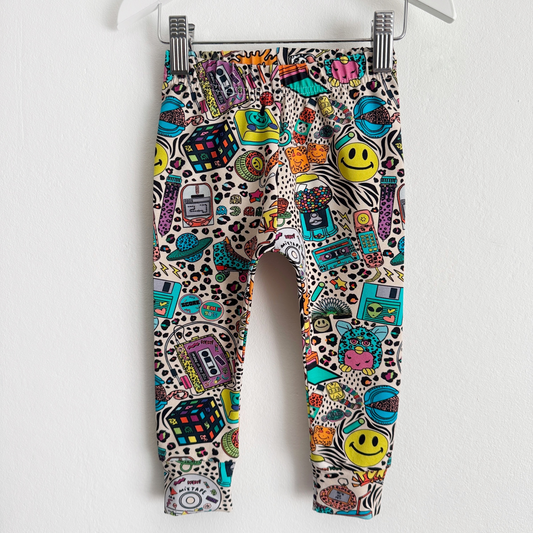 Childrens leggings with retro, 90's style designs on them with some animal print in the background